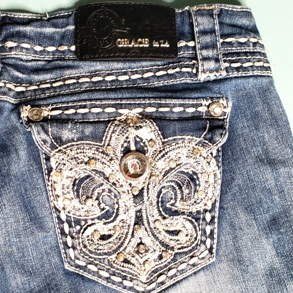 Grace in LA Distressed Light-wash Jeans. Wide flare pant legs. Women's size 29.
